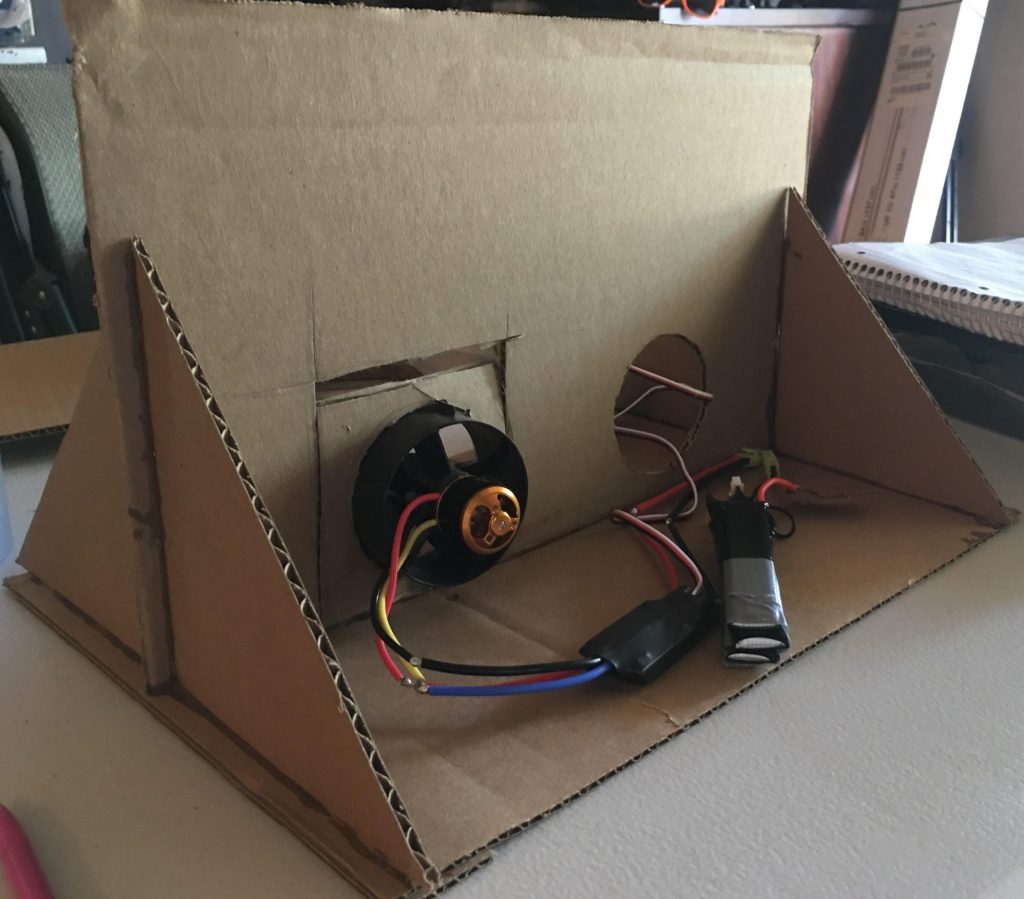 In this photo is the cardboard frame used for testing the motors.